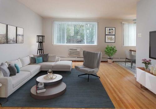 Living room with a couch, chair, and TV at Eola Park apartments for rent in Philadelphia, PA